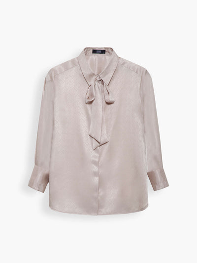 Satin Shirt with Necktie in Champagne. A versatile piece you can turn to often - plus, the soft neutral hue goes with nearly anything. Create the modern monochromatic style with the matching midi skirt and necktie or half tucked into jeans and heels for the weekend.